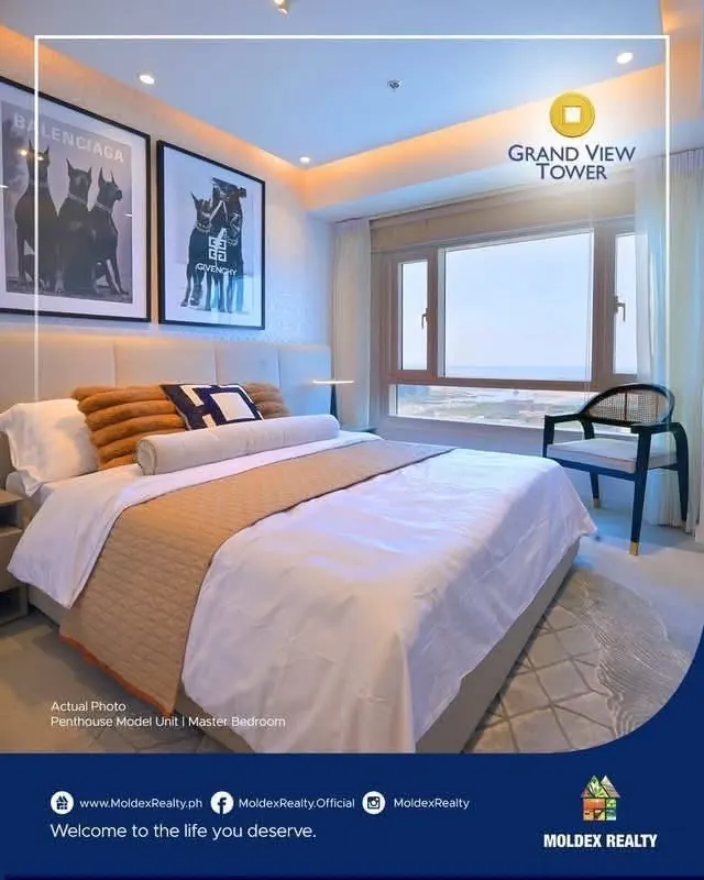 Master bedroom in the penthouse model, where an upholstered headboard faces a wide window
